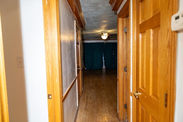 corridor featuring hardwood / wood-style floors and a textured ceiling