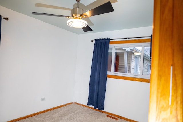 spare room with carpet floors and ceiling fan