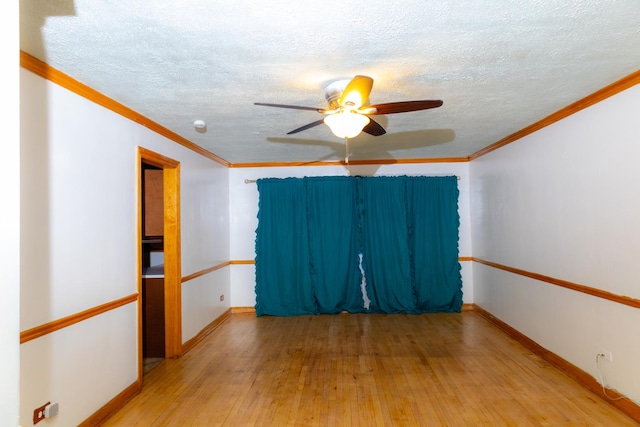 spare room with ceiling fan, light hardwood / wood-style flooring, and crown molding