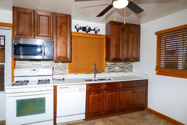 kitchen with sink, white appliances, ceiling fan, and backsplash