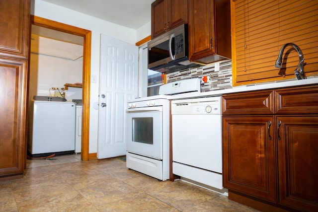 kitchen featuring tasteful backsplash, sink, and white appliances