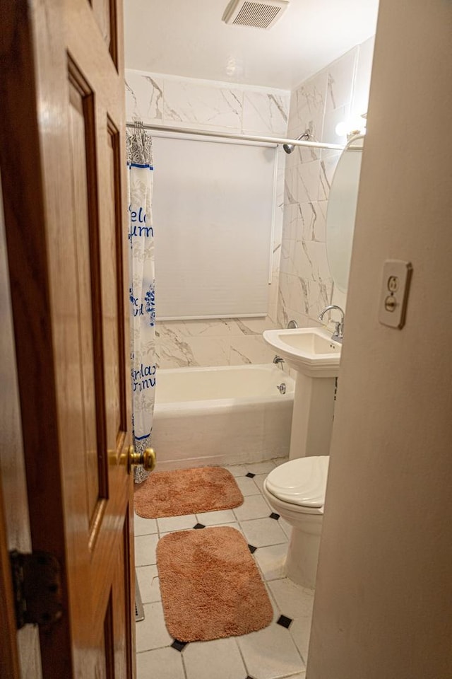 bathroom with tile patterned flooring, shower / bath combination with curtain, and toilet