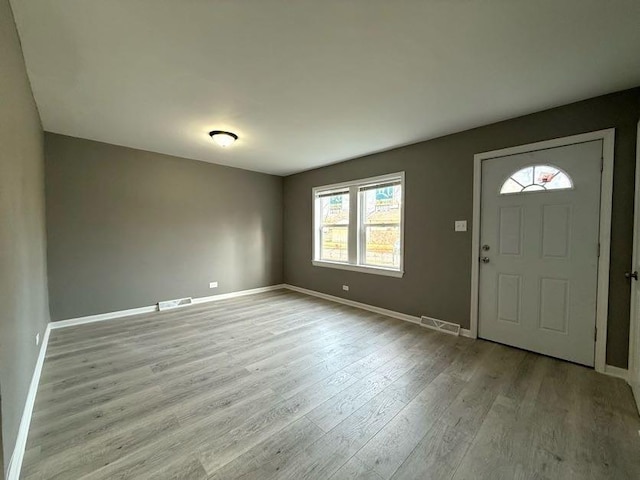 foyer entrance with light hardwood / wood-style flooring