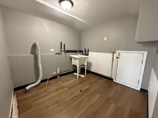 laundry area with dark wood-type flooring