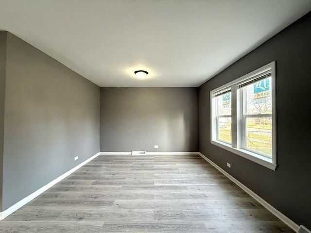 spare room with light hardwood / wood-style flooring