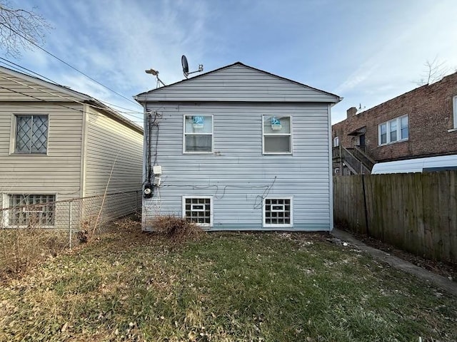 back of property featuring a lawn