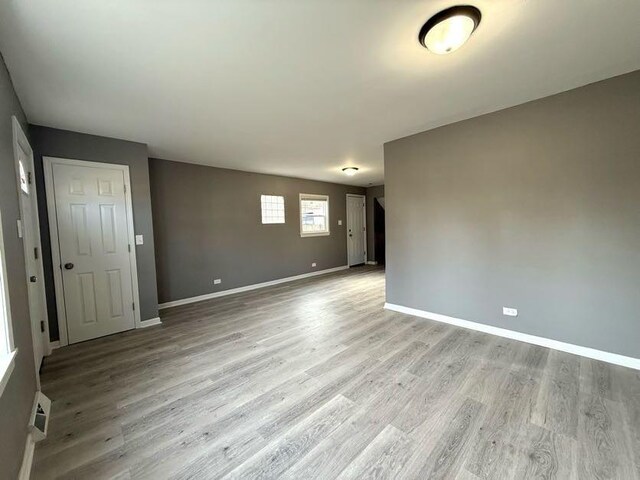 empty room with light hardwood / wood-style flooring