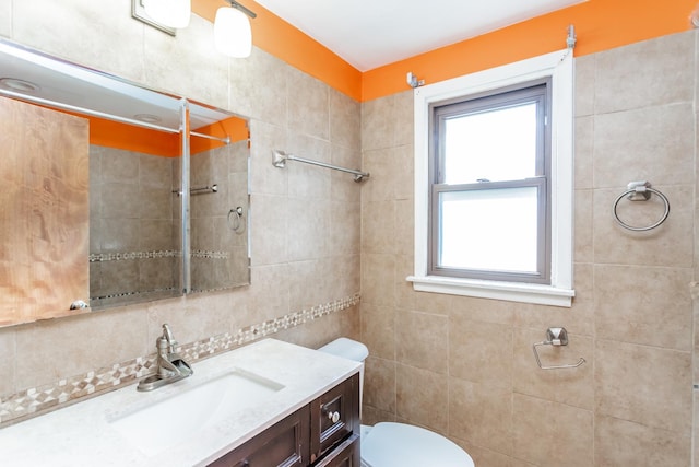 bathroom featuring decorative backsplash, vanity, tiled shower, and toilet