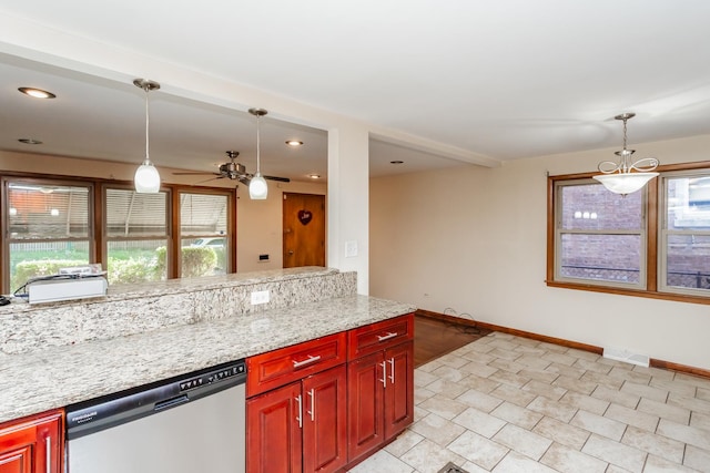 kitchen with stainless steel dishwasher, pendant lighting, light stone countertops, and a wealth of natural light