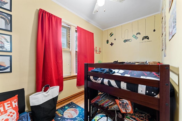 bedroom featuring ceiling fan, crown molding, and wood-type flooring