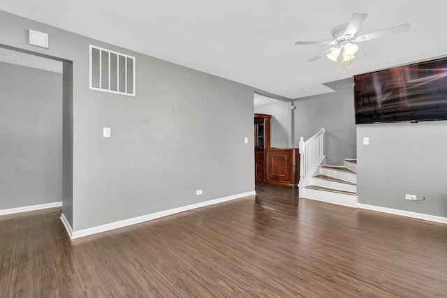 unfurnished living room with dark hardwood / wood-style floors and ceiling fan