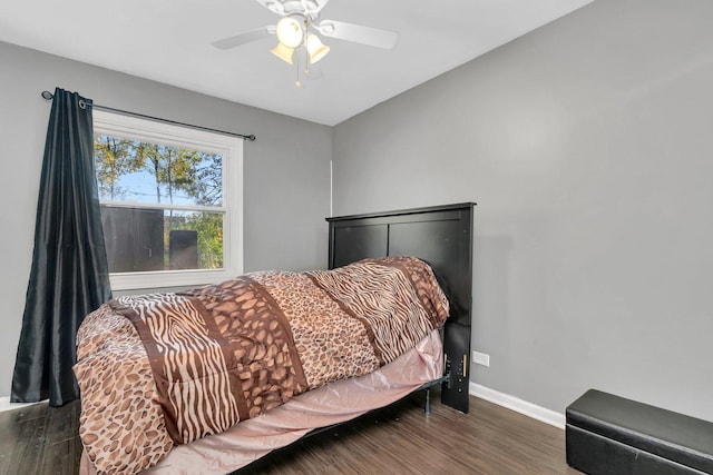 bedroom with ceiling fan and dark hardwood / wood-style floors