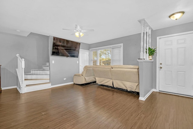 unfurnished living room with ceiling fan and dark hardwood / wood-style flooring