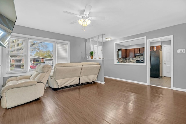 living room featuring light wood-type flooring and ceiling fan