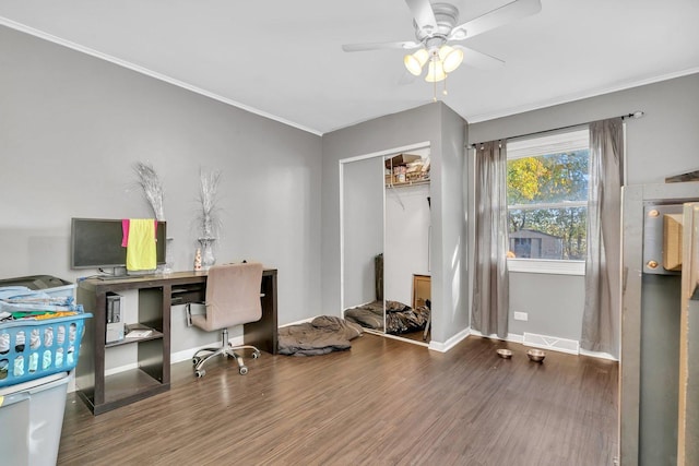 office featuring ceiling fan, ornamental molding, and dark wood-type flooring