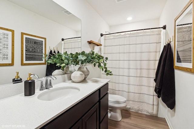 bathroom with a shower with shower curtain, vanity, toilet, and wood-type flooring