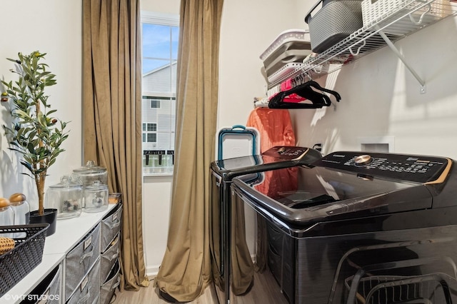 washroom with washer and dryer and wood-type flooring