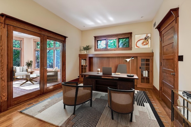 office with french doors and hardwood / wood-style floors