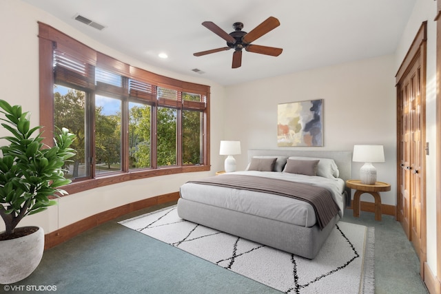 carpeted bedroom with a closet and ceiling fan