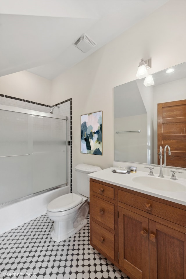 full bathroom with vanity, toilet, and combined bath / shower with glass door