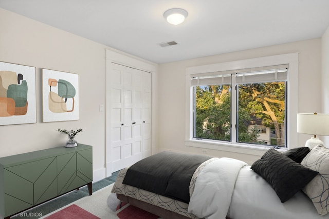 carpeted bedroom featuring a closet