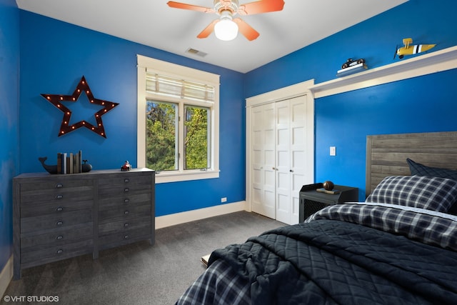 bedroom featuring ceiling fan, dark carpet, and a closet