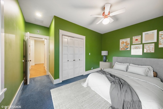 bedroom with carpet floors, ceiling fan, and a closet