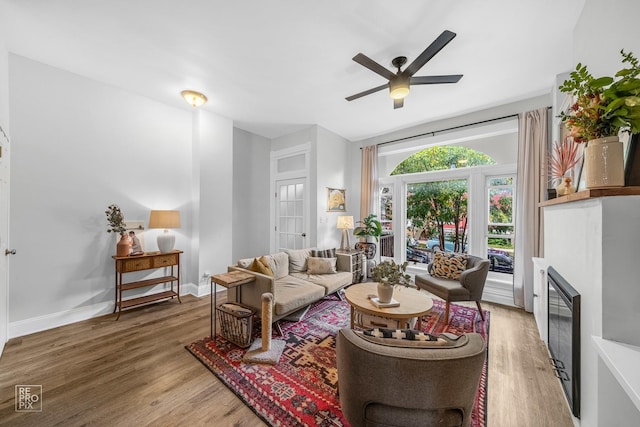 living room with hardwood / wood-style flooring and ceiling fan