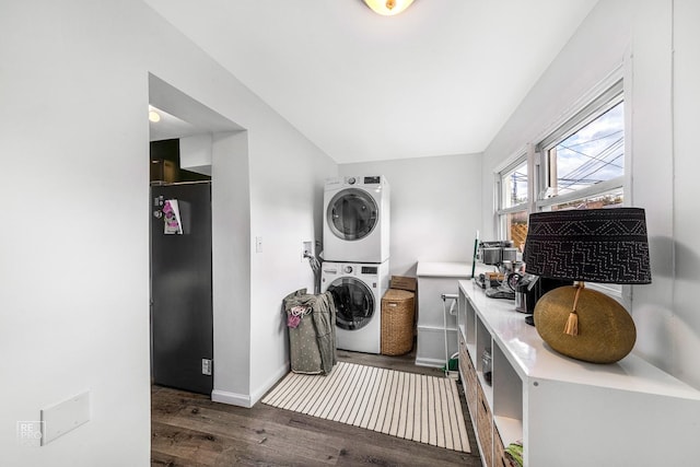 laundry room with stacked washer / dryer and dark wood-type flooring