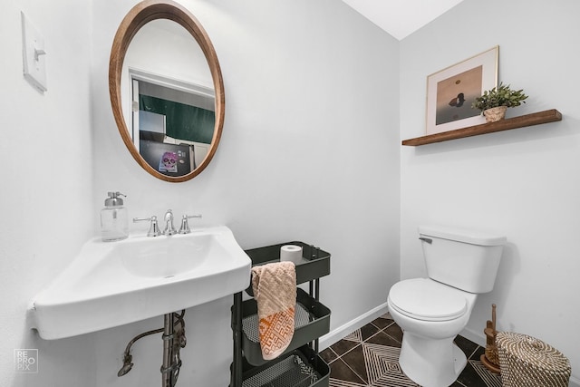 bathroom with sink, tile patterned flooring, and toilet