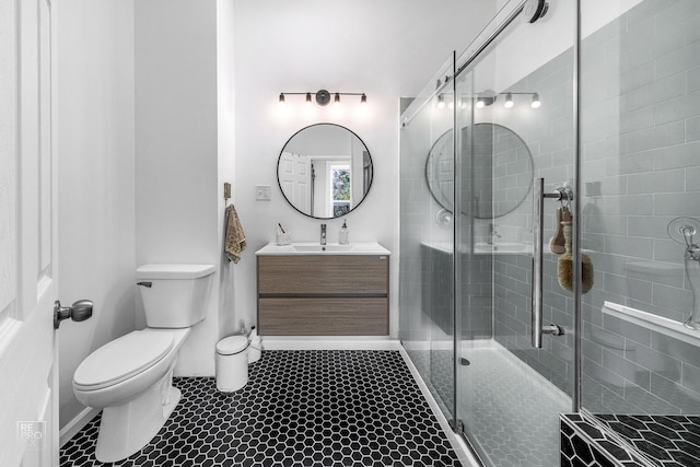 bathroom with an enclosed shower, vanity, and toilet