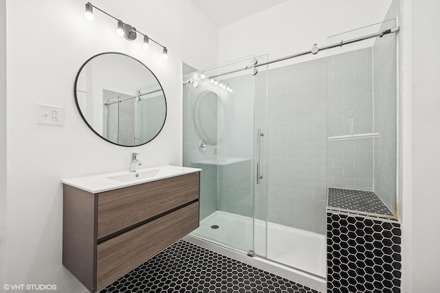 bathroom with vanity and a shower with door