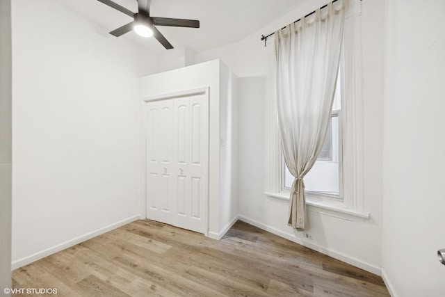 empty room featuring ceiling fan and light hardwood / wood-style floors