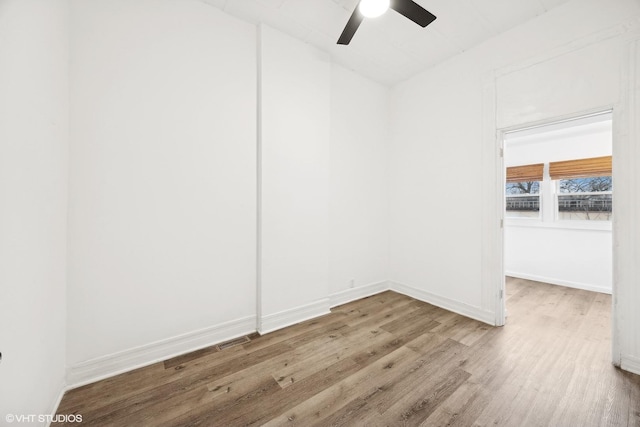 empty room with hardwood / wood-style floors and ceiling fan