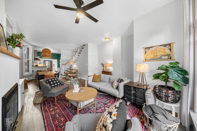 living room featuring hardwood / wood-style flooring and ceiling fan