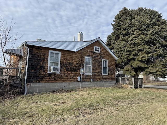 view of side of home with a lawn and cooling unit