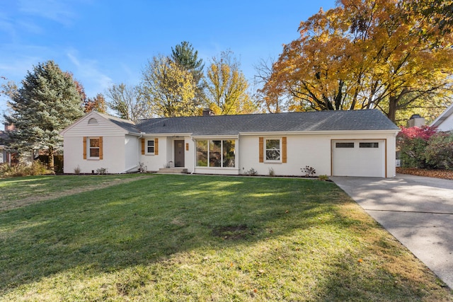 single story home with a garage and a front lawn