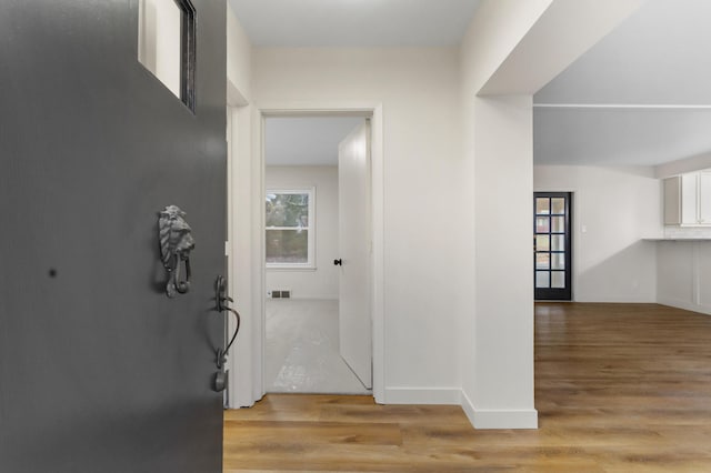 corridor with light hardwood / wood-style flooring