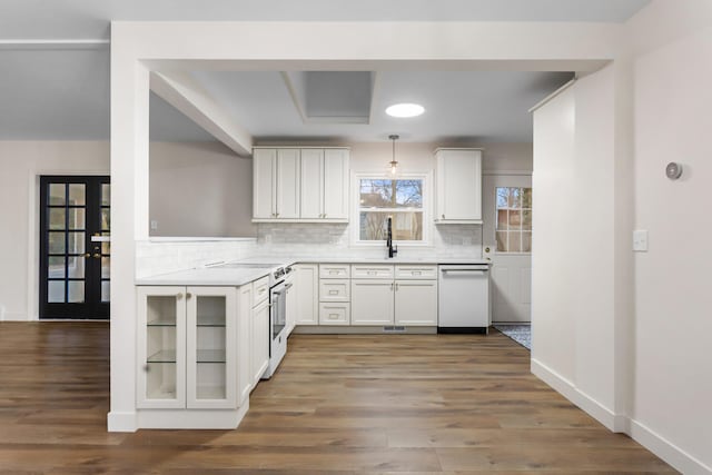 kitchen featuring decorative light fixtures, dishwasher, decorative backsplash, white cabinetry, and stainless steel range with electric stovetop