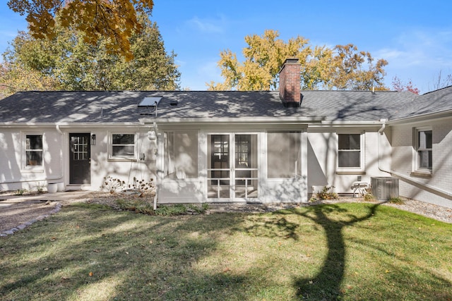 rear view of house featuring a yard and central AC unit