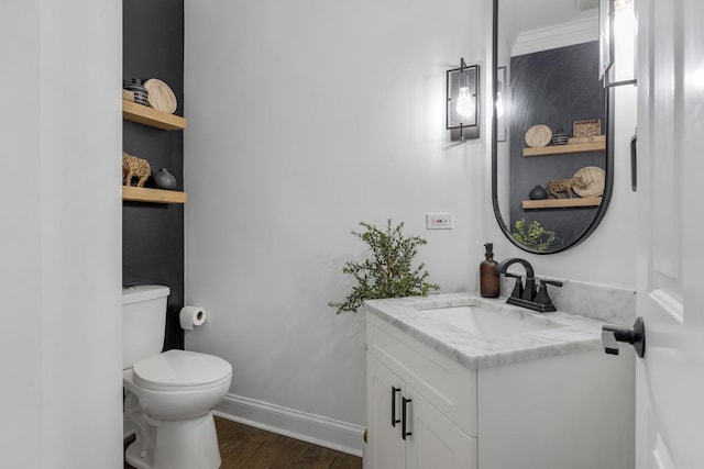 bathroom featuring vanity, wood-type flooring, and toilet