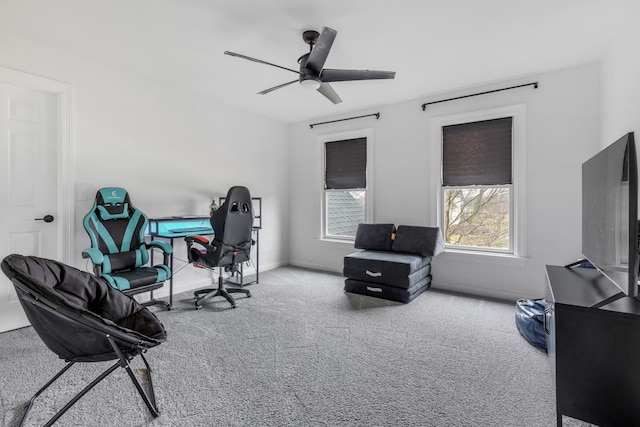 carpeted office space featuring ceiling fan