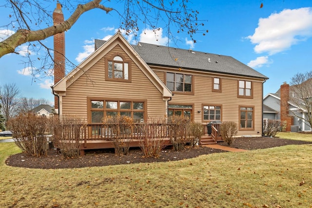 back of house featuring a wooden deck, central AC, and a lawn