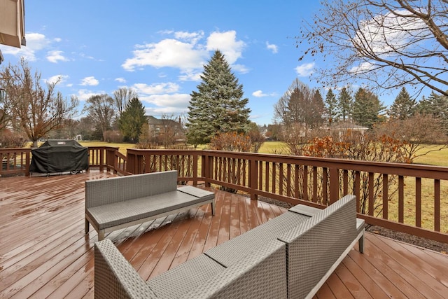 wooden deck featuring a grill