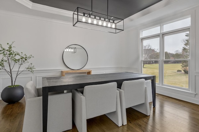 dining room with crown molding and dark hardwood / wood-style floors