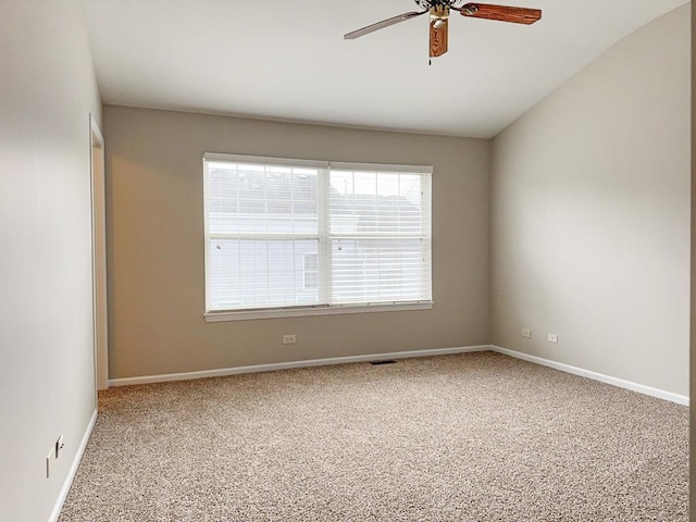 carpeted spare room featuring ceiling fan