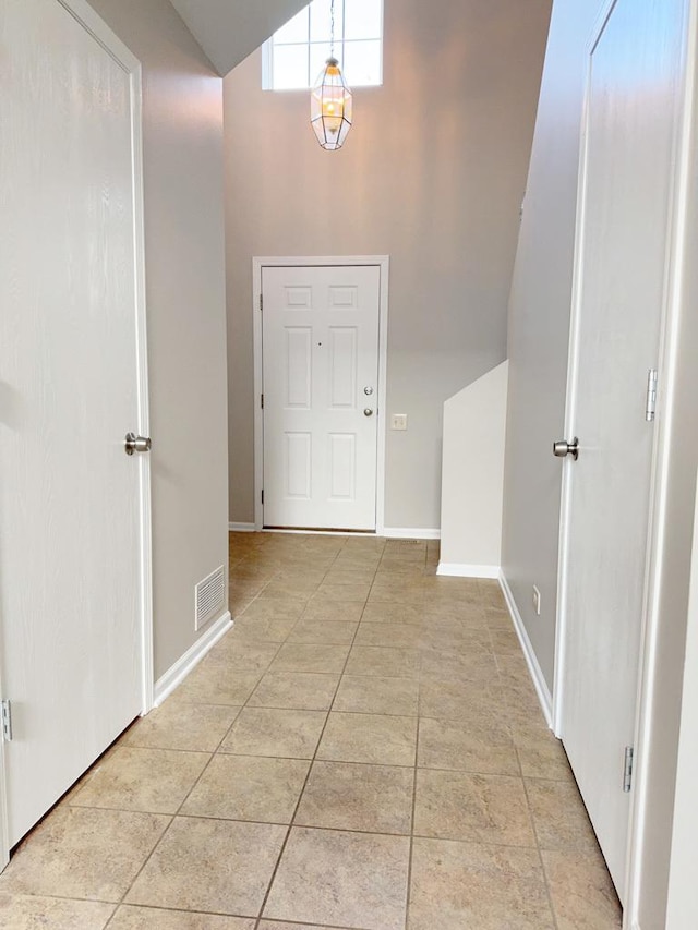 entryway featuring lofted ceiling and light tile patterned floors