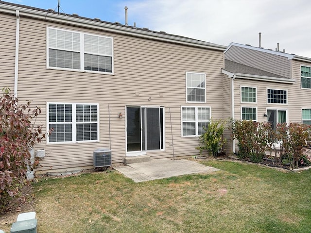 back of house with a yard, a patio, and central AC