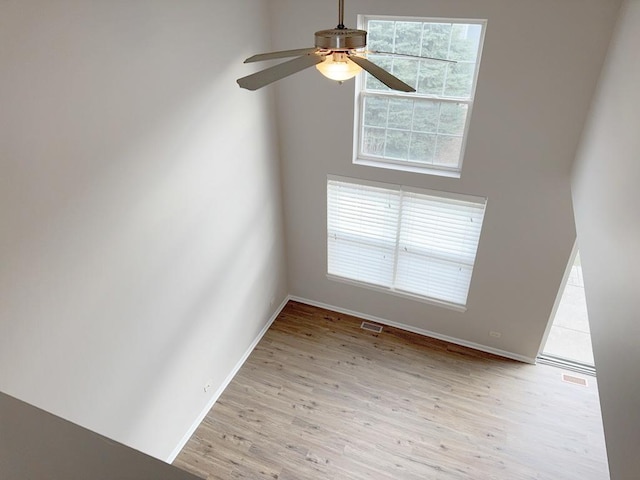 spare room with light hardwood / wood-style floors and ceiling fan