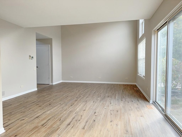 unfurnished room with a wealth of natural light and light wood-type flooring